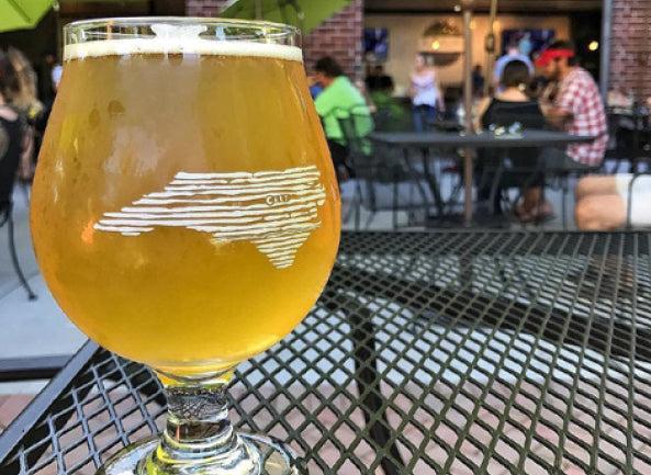 A cup of beverage on a table on the patio.