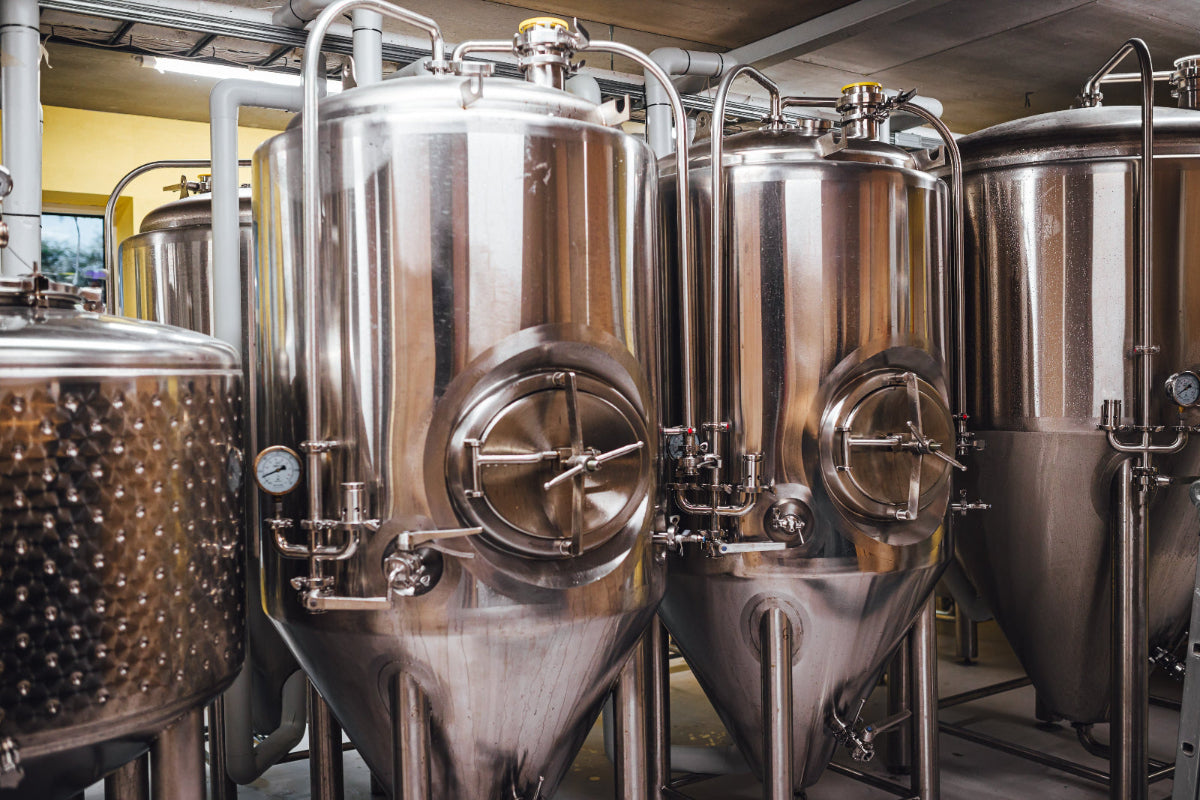 Stainless steel fermentation tanks in a brewery setting