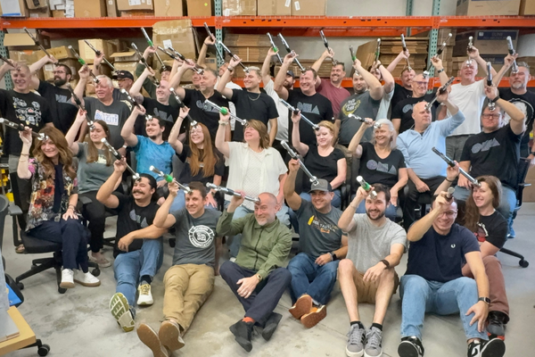 Group of people in a warehouse holding SennosM3 above their heads