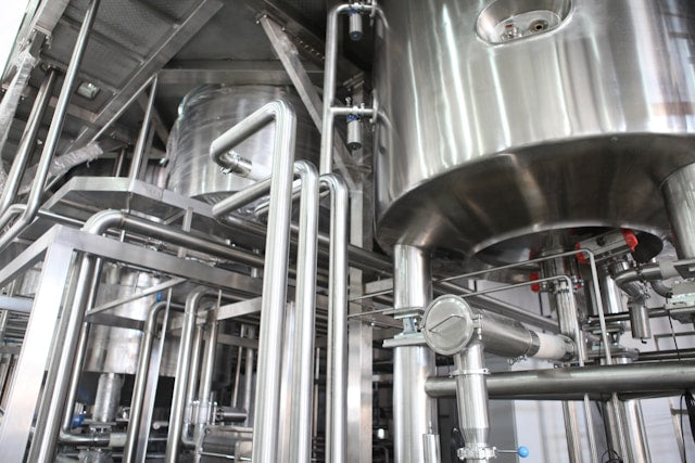 A row of brewery tanks.